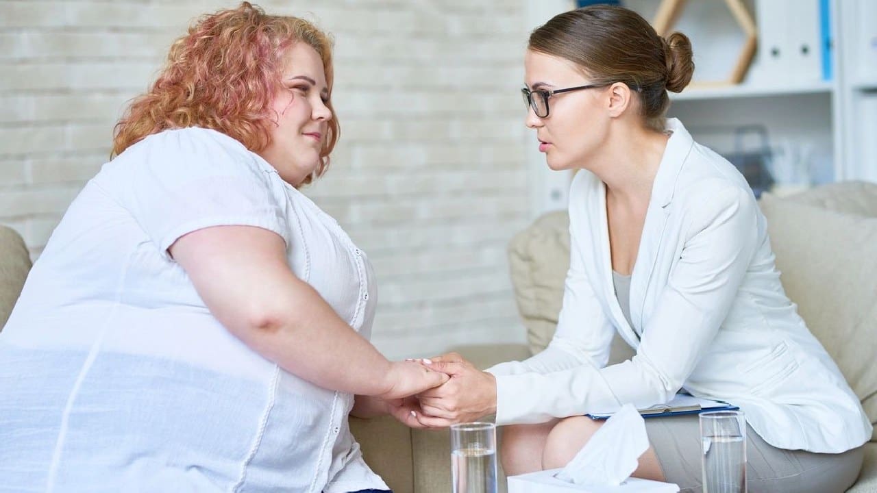 A woman holding hands with another person.
